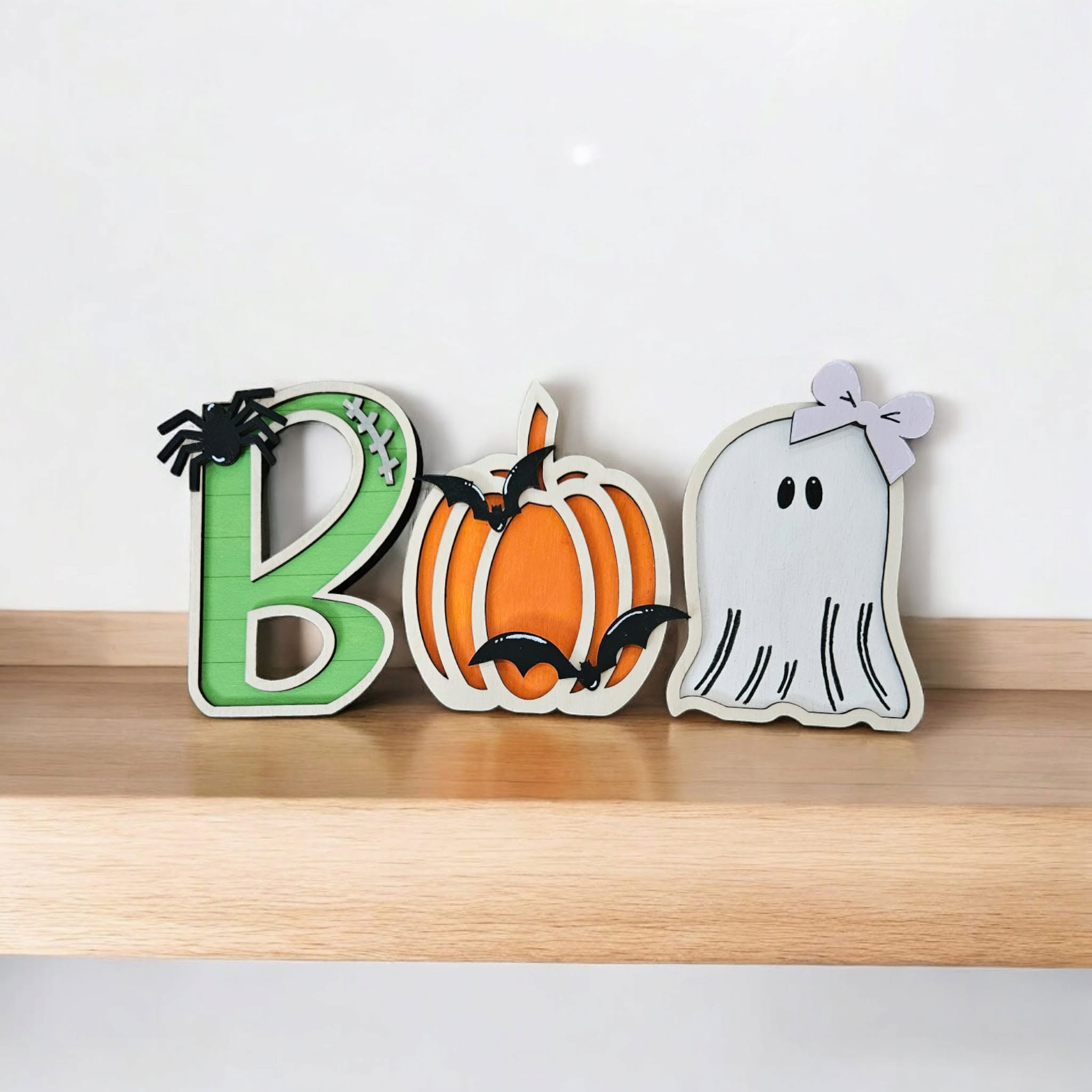 Colorful layered wooden BOO Halloween decoration with a pumpkin and ghost