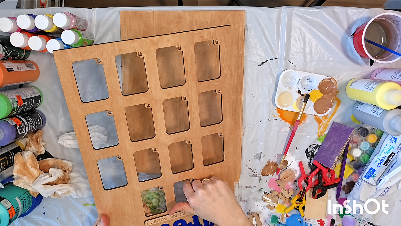 Amy painting and assembling a wooden school-years picture frame