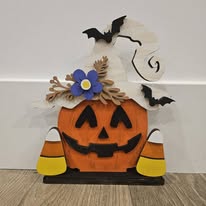 Hand-painted jack-o-lantern wearing a witch hat with candy corn accents